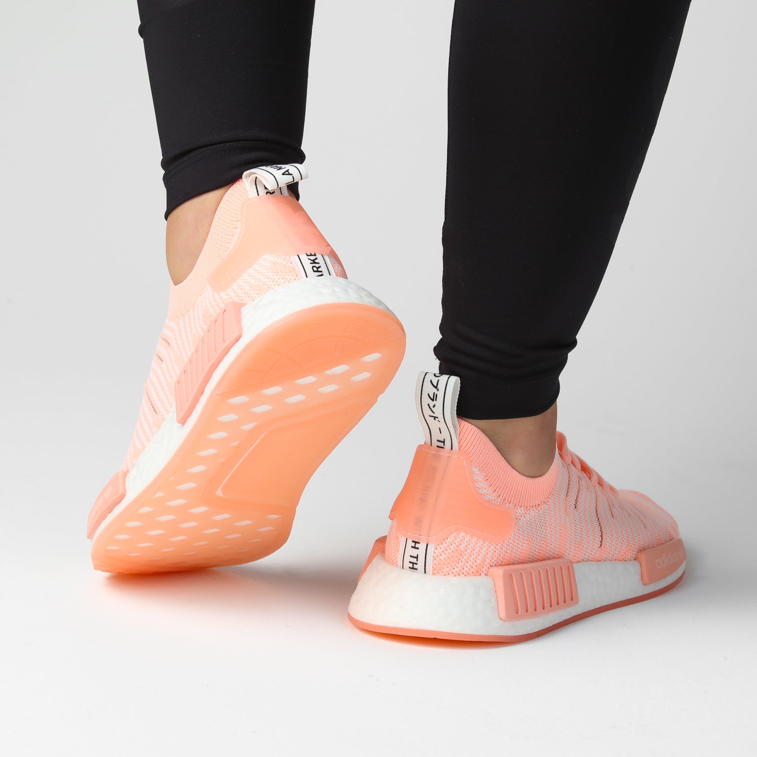 nmd_r1 stlt primeknit shoes clear orange