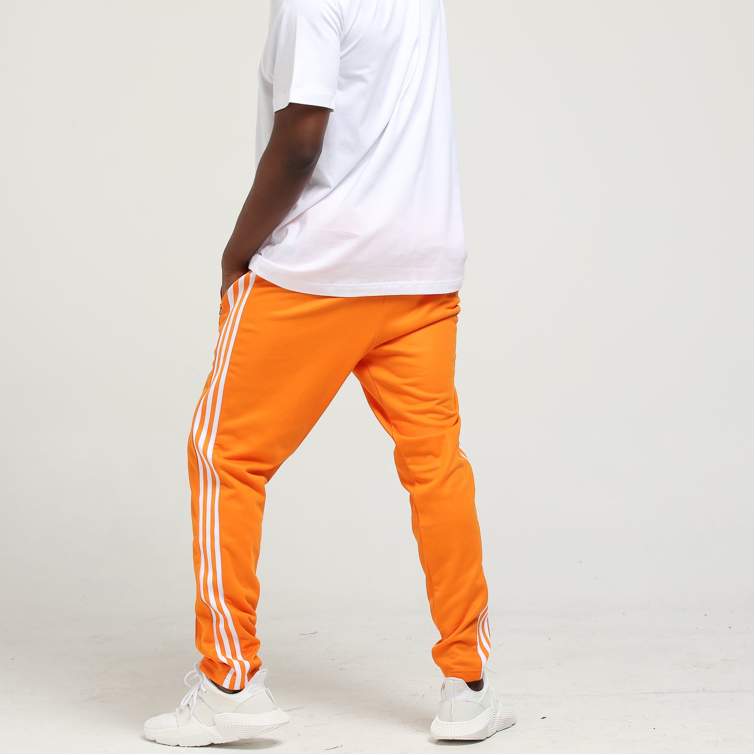 adidas beckenbauer track pants orange