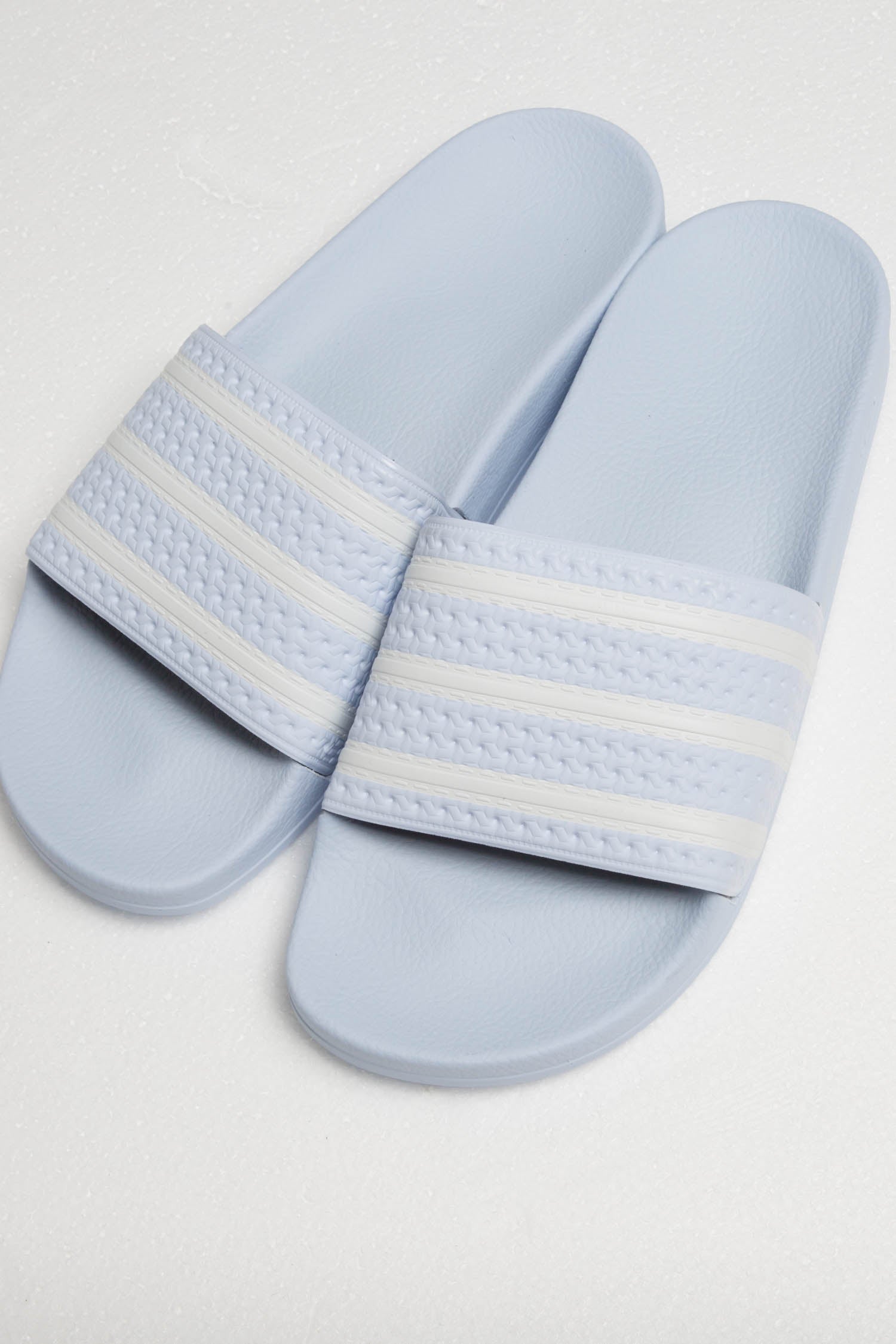 blue and white adidas slides