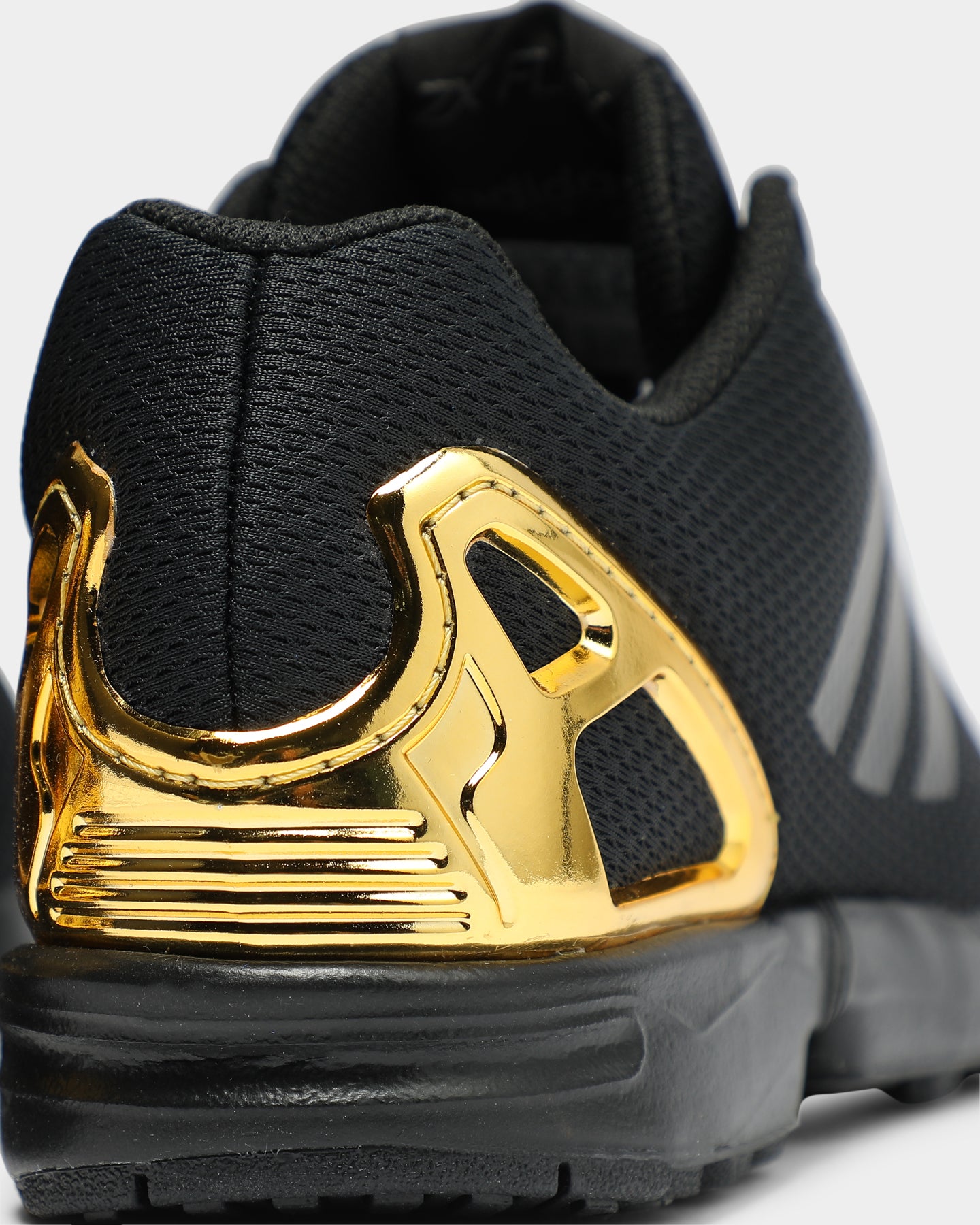 black and gold adidas flux