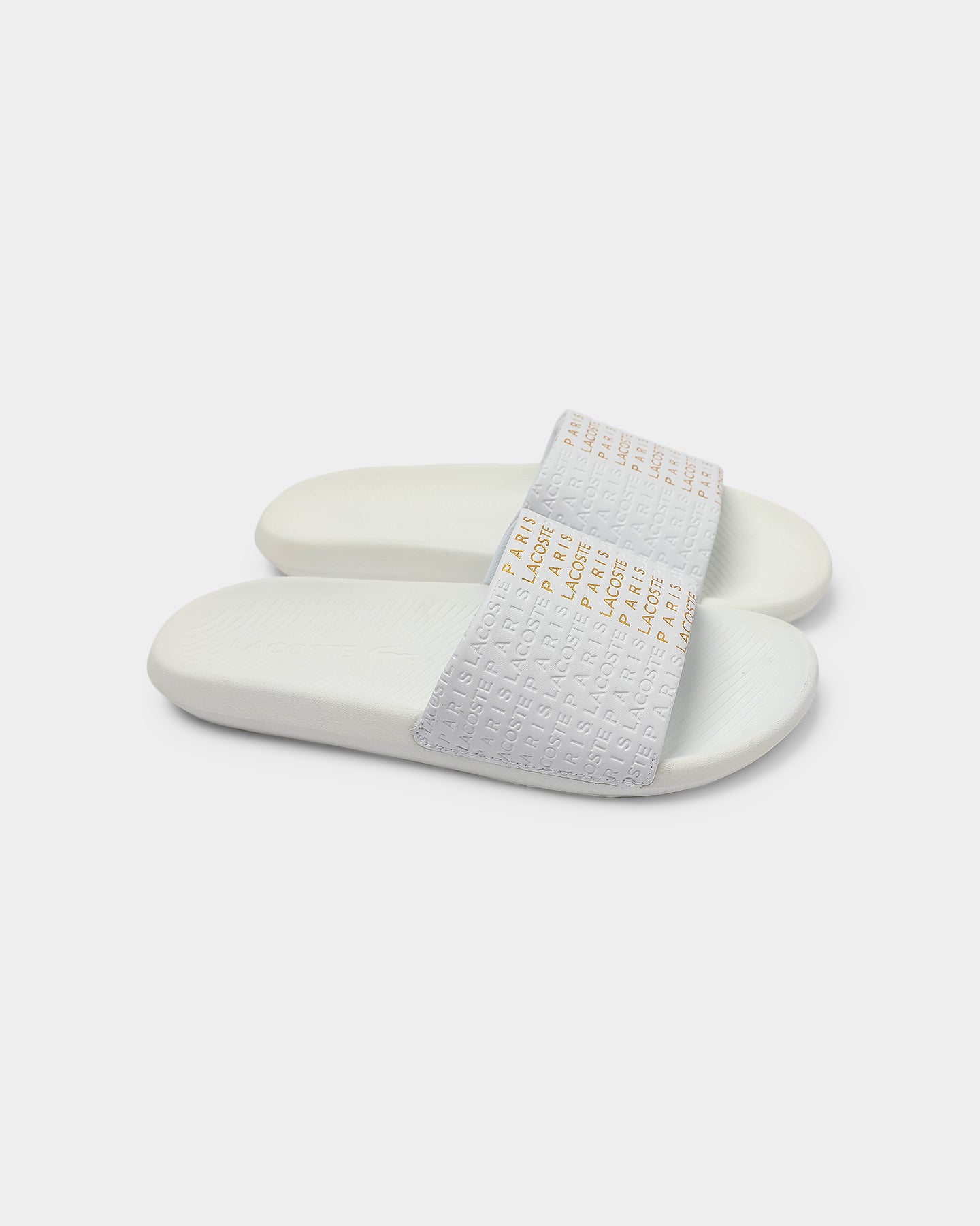 white and gold lacoste slides